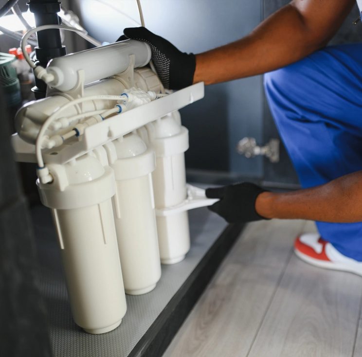 Technician installing an under-sink reverse osmosis system